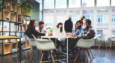 Following on from our last blog, we return to the research paperThe Enticing Workplace: Attracting People Back to the Office (see https://bit.ly/46q8Iyk ) and the supplementary discussion article(see https://bit.ly/3YleNdz ). These excellent resources delve into the comparative merits and challenges of homeworking and office working, using research into what factors influence employees’ preferences to answer the question, ‘How can we create offices that entice workers to spend more time there?’ Please read the previous blog to learn more about this research's approach and results. Here, we explore some of the key conclusions. Insights and thinking points Guy Osmond, MD of Osmond Ergonomics, says: “This is an exciting piece of work that seeks to define and codify what can be a bewildering set of considerations for most people. It picks out useful concepts, encapsulates important ideas, and clearly summarises the key factors employers should consider. It benefits from all those involved being people with real experience working in or with big corporations. “One of the key things to note is there is no one solution – people have different needs and different reasons for those needs. It also clearly illustrates that this is far more nuanced than the duality of ‘collaboration in the office’ vs ‘concentration at home’ as has often been presented. “Distraction is a topic that has kept cropping up. A sense of control is very important, and people report feeling a greater sense of control over the working environment in their homes. There is the psychology around feeling empowered to make choices – not just around controlling noise, but also air quality and temperature – all of which are automated and centrally controlled in large corporate offices. It might be something as simple as being able to open a window in your own home. Nigel points out in the discussion that the best example of air quality he’d come across was in an office where people could open the window – not a huge surprise there!” Adds Guy: “I was also particularly struck by the phrase ‘line of sight management’ in the panel discussion. It’s a term I haven’t come across before, but it neatly encapsulates the idea of middle managers managing employees’ output by ‘seeing’ what they are doing. It’s been seen as a rather ‘lazy’ reason to require people to return to the office. But, as pointed out in the discussion piece, line of sight management is also important for determining wellbeing and performance – managers ‘see’ how employees are doing, how they’re coping with workloads, the team dynamics and so on. “There is so much relevant material here that neatly summarises much of my experience and the experience of others with an interest in workplace wellbeing. Since Covid, I have been talking about the ‘magnetic office’ and the need to create workplaces that draw people in, maximising the advantages and supplementing them with further benefits that work for individuals, as well as ultimately serving the needs of the business. Together, this report and panel discussion are a great step towards unpickinghow you might do that – the factors at play, their influence, and the levers that employers can pull.” Ways to entice people back into the office The Enticing Office not only explores what influences whether people prefer home over the office or vice versa, but it also highlights the key areas employers can focus on to make the office more attractive and appealing and suggests actions they could take. Again, this is well worth a read in full – but a precis is below: Focus and Concentration, Noise and Privacy Reduce desk density to allow control of environmental conditions. Reduce distraction and noise and provide both visual and acoustic privacy—e.g. use screens, bookshelves, plants and pods to break up open-plan spaces. Provide spaces for focus and concentration – e.g. rooms, pods and booths. Collaboration and Socialising Provide spaces for interaction, collaboration, teamwork, socialising, and connecting. These have all been identified as key reasons for coming to the office. Travel and Flexibility Offer more options for travel, work hours, exercise, and childcare. Consider subsidised travel or loans for rail tickets. Consider on-site wellness facilities, subsidised membership in nearby gyms, spas, or clubs, and access to crèches and subsidised lunches. Purpose and Events Emphasise and enhance the reasons to visit the office—connection, culture, and sense of belonging—through meetings, social gatherings, and leadership. For example, regular team catch-ups, introducing new staff members, charity events, hobbies clubs and on-site fitness classes. Motivational Culture Create a motivating culture through leadership, encouragement, loyalty, and work ethic. Workplace design and the relevant facilities can help foster the organisational culture, though ultimately, it comes from the leadership team. Consider Differences Take account of individual differences and personal circumstances, including family or healthcare issues or the needs of those just starting out in their careers. Consider what attracts different personality types and design for their requirements. Assigned Desks Implement unassigned desking only with caution - a higher proportion of respondents with assigned or allocated desks reported they preferred working in the office than those with unassigned desks. Provide allocated desks to those who genuinely need them, not based merely on seniority, and manage usage to ensure that staff have a desk when choosing to work in the office. There is a clear call to arms here. As this research demonstrates, there is a great deal to recommend the office environment. Even with the appeal of homeworking, it remains a place that can better support key working behaviours, especially the need for privacy, teamwork, and a sense of purpose. By tackling issues like distraction and noise, improving technology, and boosting personal benefits by allowing for greater flexibility, a balance can be struck, meeting employees' shifted expectations and need to maximise wellbeing and productivity.